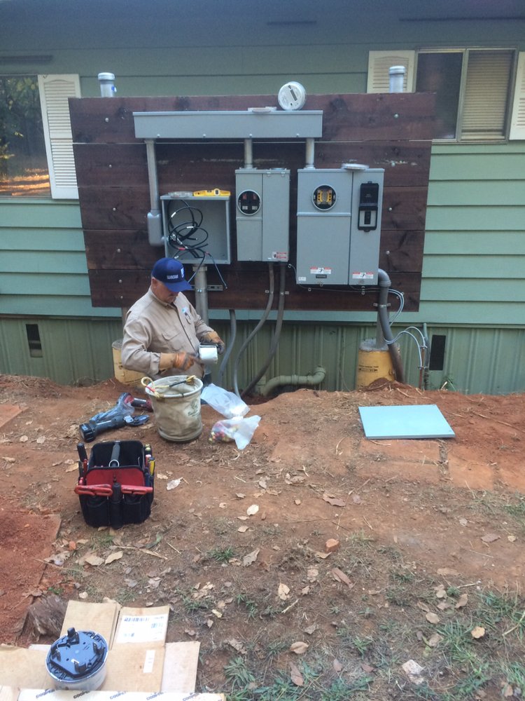 Jeff McEvoy working on an exterior electrical panel upgrade